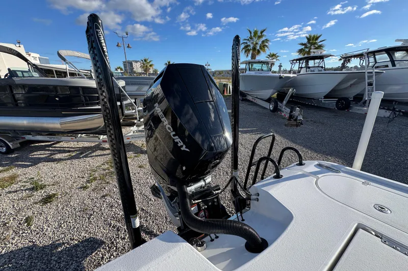 Slide: The Image of 2025 Blazer Bay 2700 Hybrid boat with Mercury engine, parked in a marina under blue skies. - 41