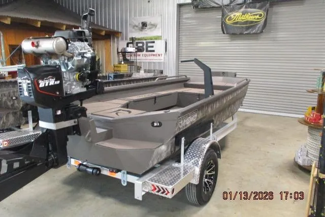 The Image of 2026 Reaper Boats 656 Mud Boat on trailer in a garage setting. - 0