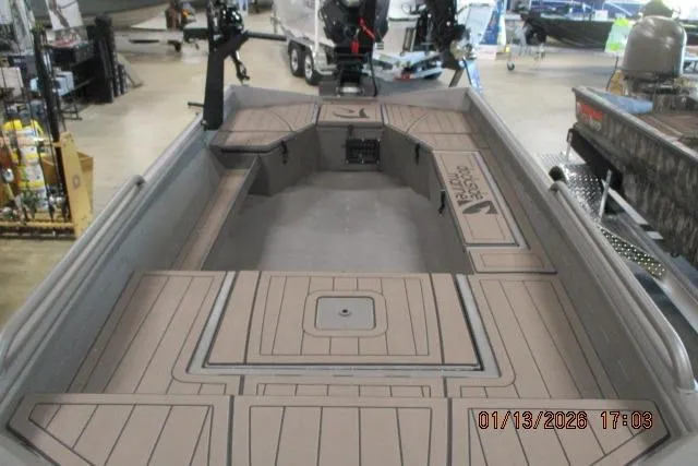 Slide: The Image of 2026 Reaper Boats 656 MUD BOAT on trailer in showroom setting. - 2