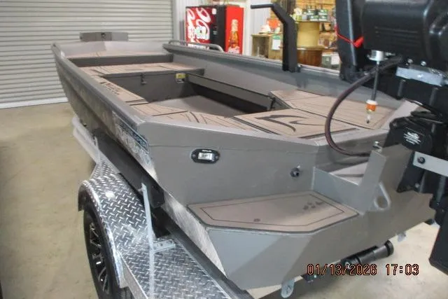 Slide: The Image of 2026 Reaper Boats 656 MUD BOAT on trailer in garage setting. - 3
