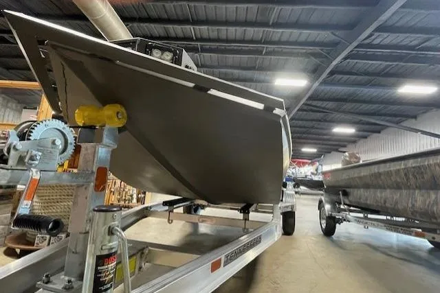 Slide: The Image of Reaper Boats 656 MUD BOAT 2026 on trailer in warehouse. - 9