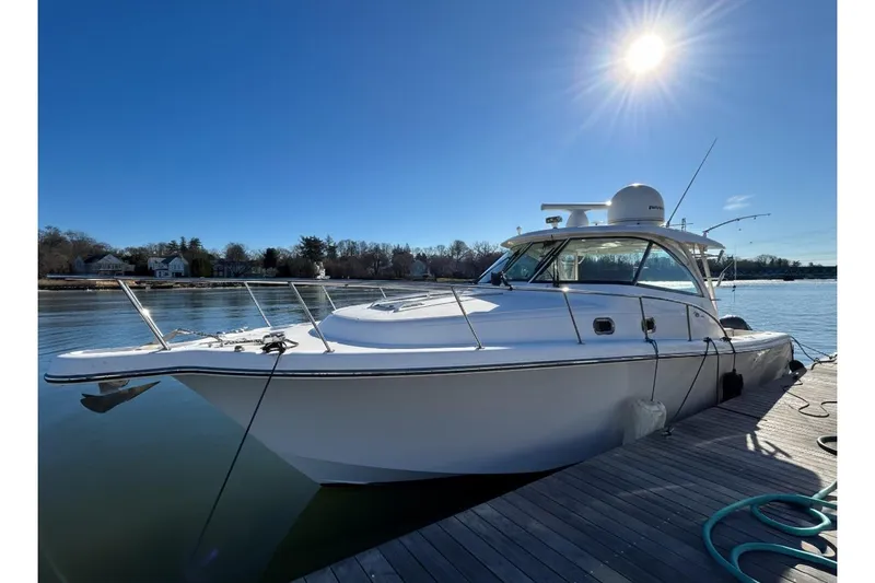 The Image of 2018 Pursuit OS 385 Offshore boat docked under clear blue sky. - 0