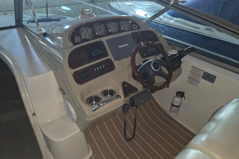 Slide: The Image of 2005 Chaparral Signature 310 boat cockpit with steering wheel and control panel. - 10