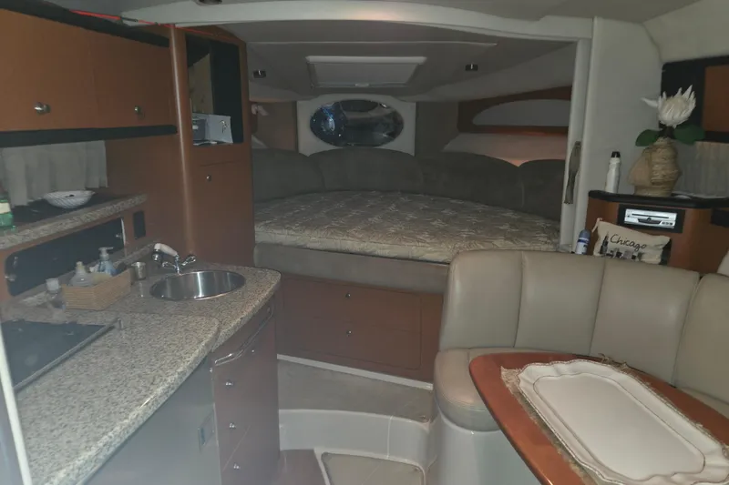 Slide: The Image of Interior of 2005 Chaparral Signature 310 boat with kitchenette and cozy sleeping area. - 17