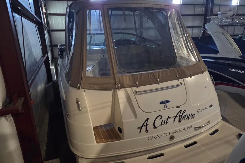 Slide: The Image of 2005 Chaparral Signature 310 boat in storage, rear view with cover, "A Cut Above" text. - 2