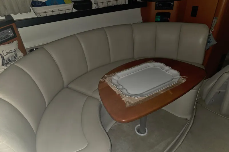 Slide: The Image of 2005 Chaparral Signature 310 interior with curved seating and wooden table. - 21