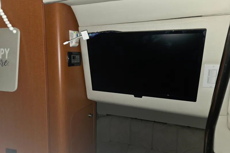 Slide: The Image of Interior of 2005 Chaparral Signature 310 with mounted TV and control panel. - 22