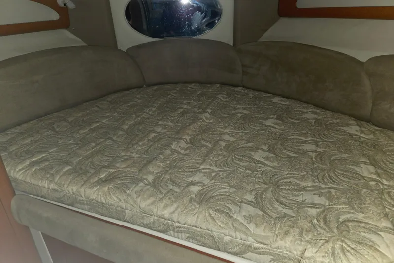 Slide: The Image of 2005 Chaparral Signature 310 cabin interior with patterned bed and oval window. - 24