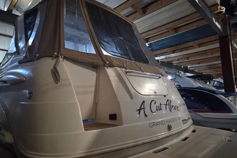 Slide: The Image of 2005 Chaparral Signature 310 boat in storage, featuring "A Cut Above" name on stern. - 3
