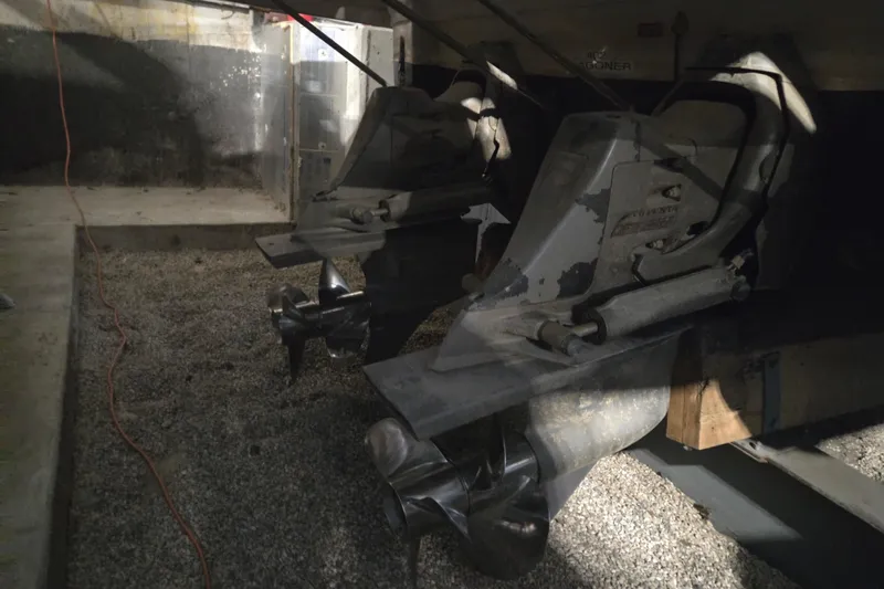 Slide: The Image of 2005 Chaparral Signature 310 boat propellers in a dimly lit storage area. - 31