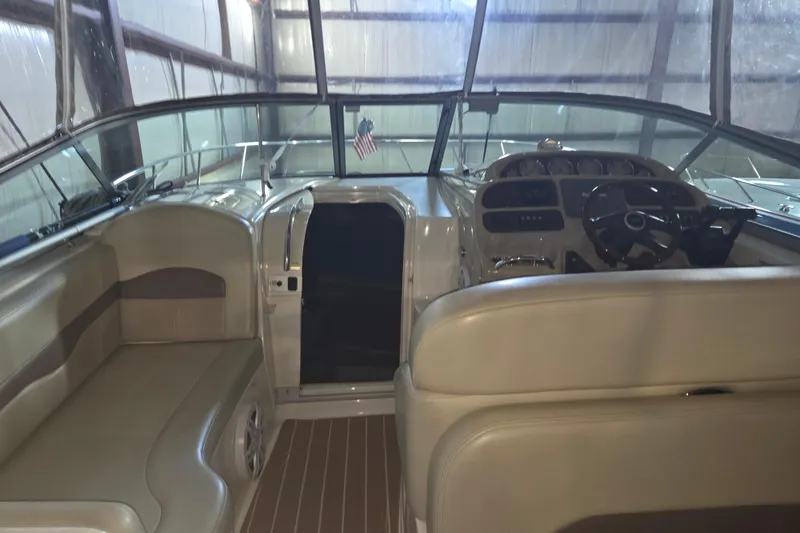 Slide: The Image of 2005 Chaparral Signature 310 boat interior with beige seating and steering console. - 6