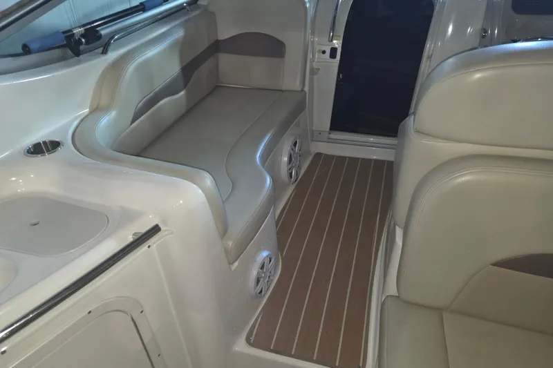 Slide: The Image of 2005 Chaparral Signature 310 interior with beige seating and wood-patterned flooring. - 7