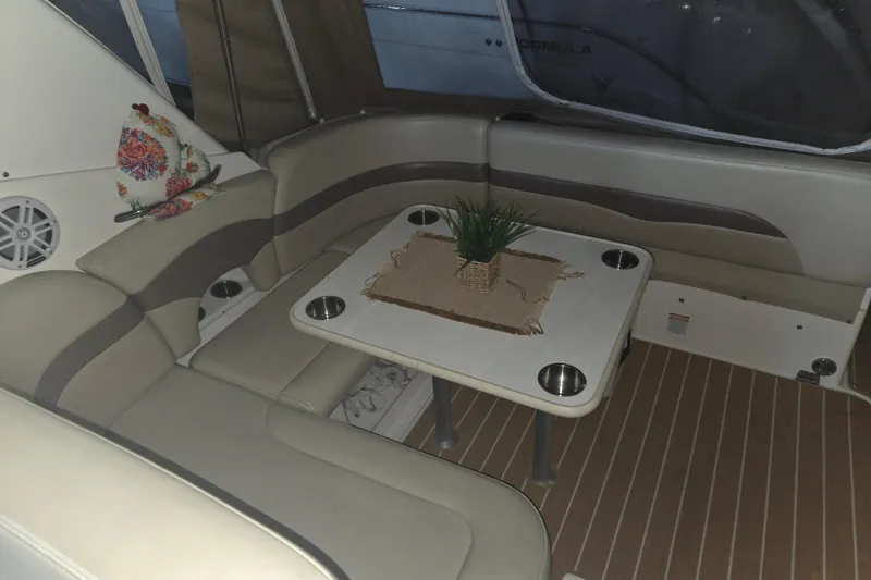 Slide: The Image of 2005 Chaparral Signature 310 interior with beige seating and table, featuring a decorative plant. - 9
