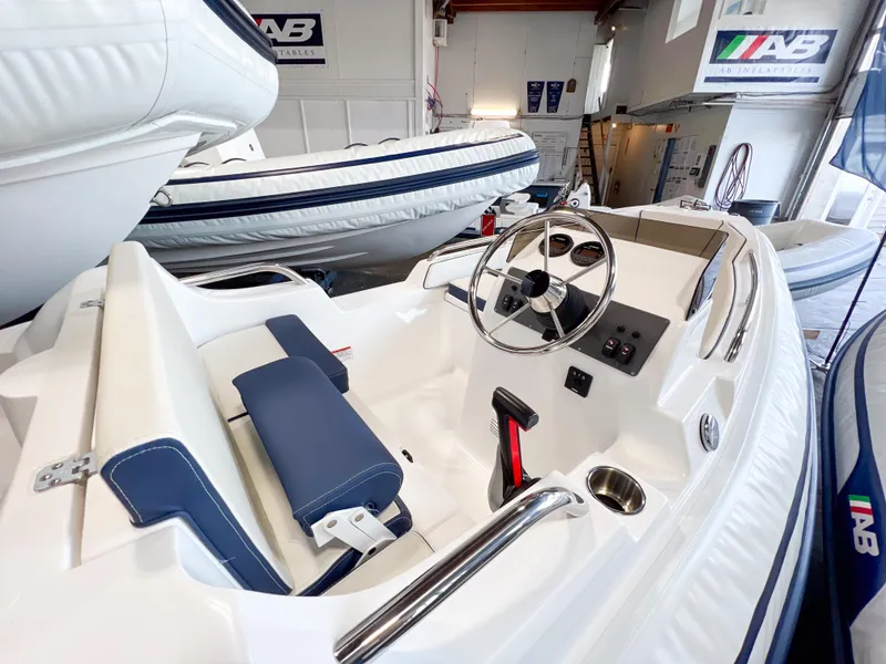 Slide: The Image of 2023 AB Inflatables Nautilus 13 DLX boat interior with steering wheel and seating. - 14