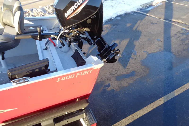 Slide: The Image of 2024 Lund 1400 Fury Tiller boat with Mercury outboard motor on a snowy day. - 10