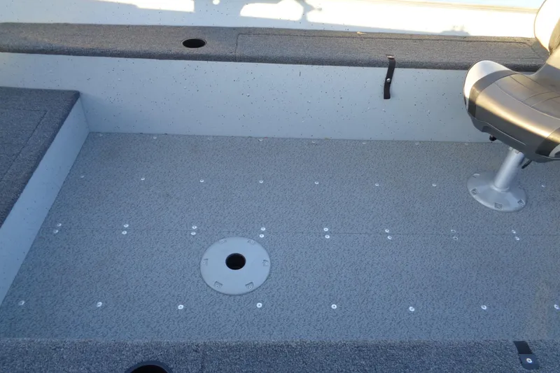 Slide: The Image of 2024 Lund 1400 Fury Tiller boat interior with seating and carpeted floor. - 23