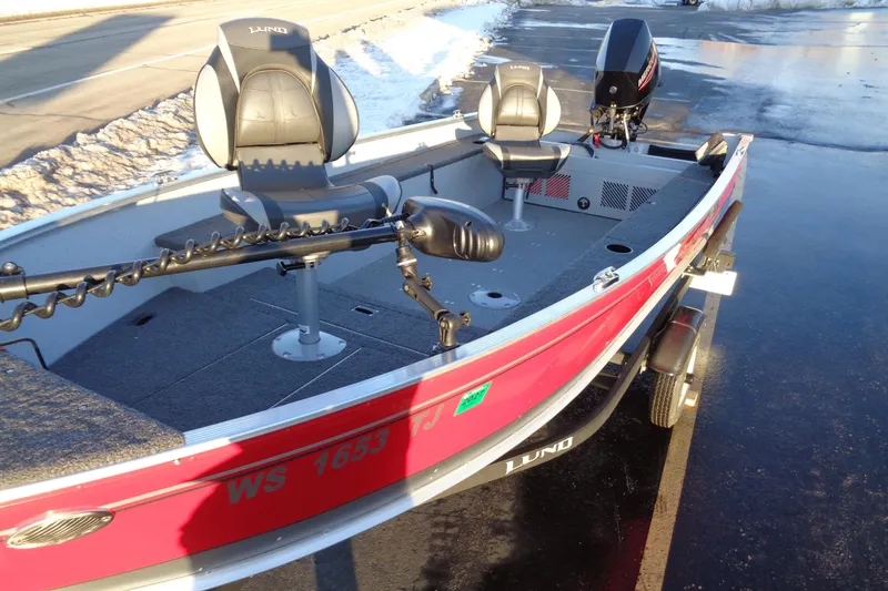 Slide: The Image of 2024 Lund 1400 Fury Tiller boat with dual seats and motor on a trailer. - 7
