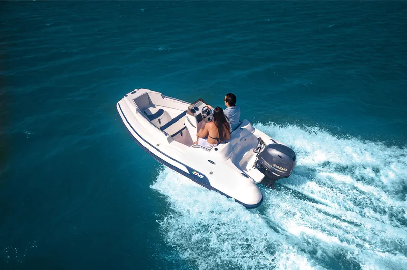 Slide: The Image of 2024 AB Inflatables Nautilus 13 DLX cruising on open water. - 4