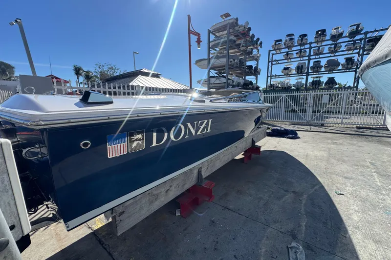 The Image of 2002 Donzi 22 Shelby GT boat on display at a marina under clear blue sky. - 0