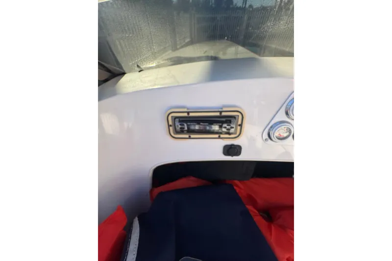 Slide: The Image of Dashboard of a 2002 Donzi 22 Shelby GT boat with gauges and stereo system. - 11