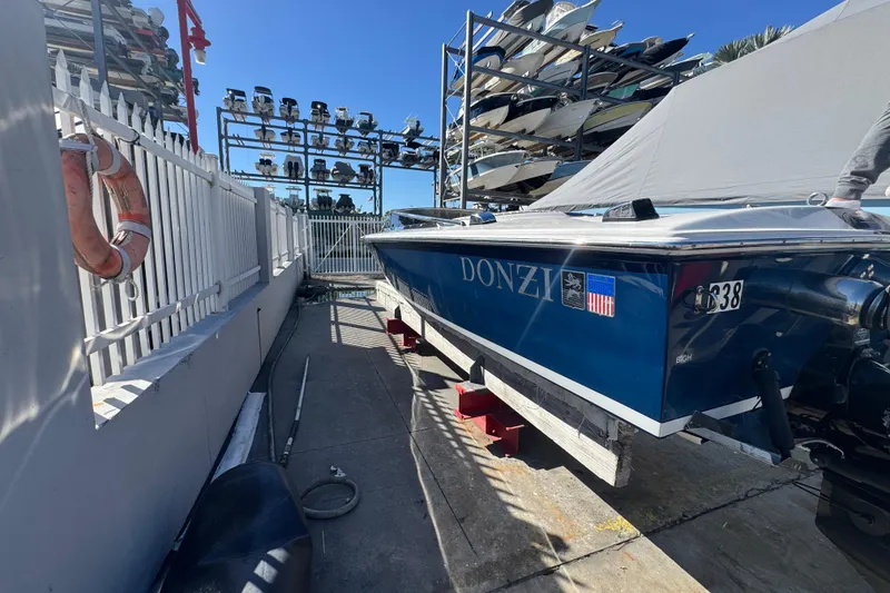Slide: The Image of 2002 Donzi 22 Shelby GT boat in storage, surrounded by other boats and equipment. - 3