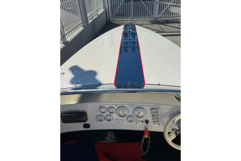 Slide: The Image of 2002 Donzi 22 Shelby GT boat dashboard with blue racing stripe. - 5