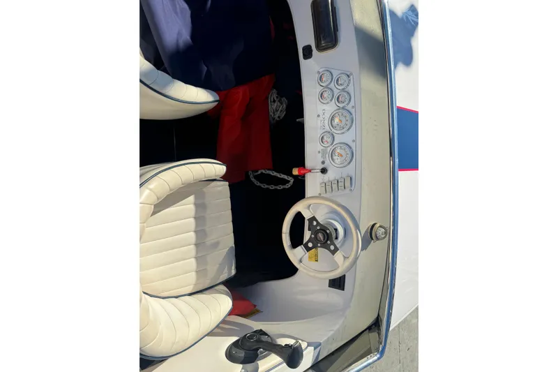 Slide: The Image of Interior of a 2002 Donzi 22 Shelby GT boat with steering wheel and gauges. - 6