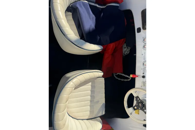 Slide: The Image of Interior of a 2002 Donzi 22 Shelby GT boat with white leather seats and dashboard. - 8