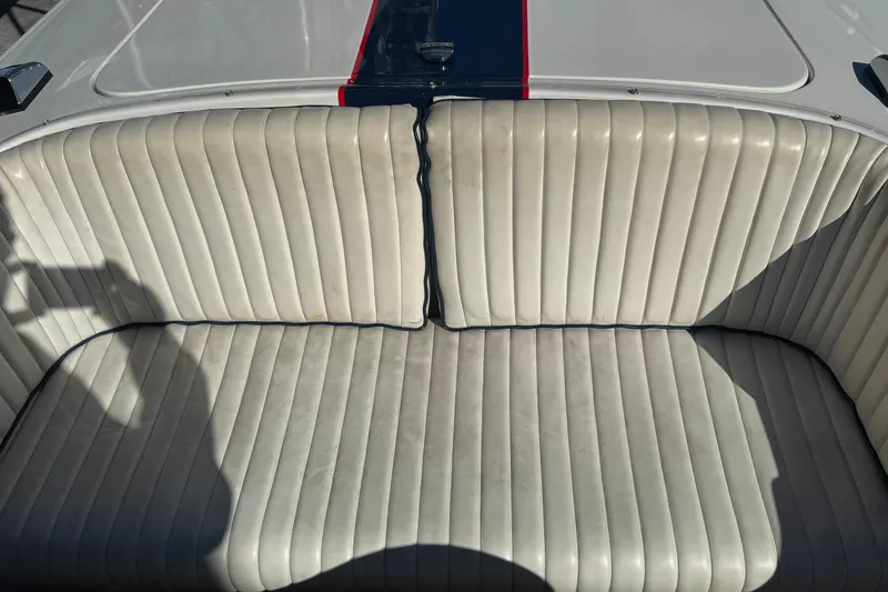 Slide: The Image of 2002 Donzi 22 Shelby GT boat interior with white cushioned seating and red stripe detail. - 9