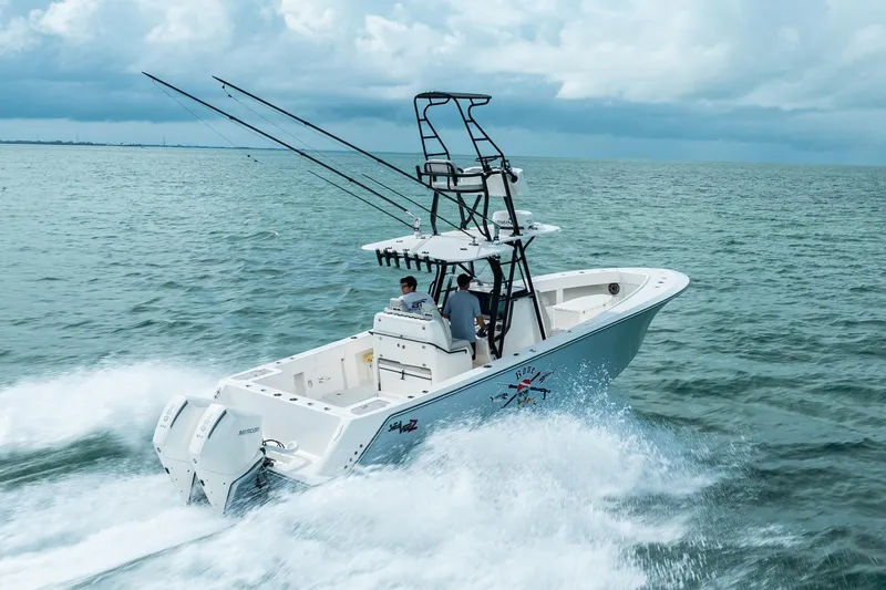 Slide: The Image of SeeVee 32 boat cruising on open water, 2099 model, with dual outboard engines. - 11