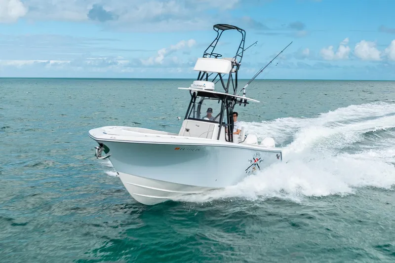 Slide: The Image of SeeVee 32 boat cruising on open water, 2099 model, under clear blue skies. - 15