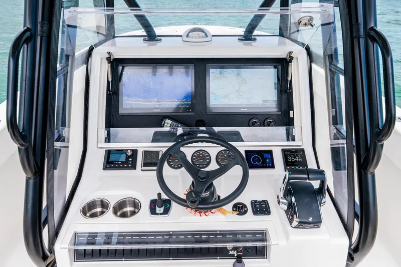 Slide: The Image of Futuristic SeeVee 32 boat dashboard with advanced navigation screens, steering wheel, and controls. - 33