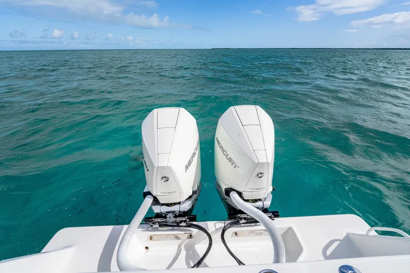 Slide: The Image of Twin Mercury outboard engines on a SeeVee 32 boat, 2099 model, in clear blue ocean. - 46