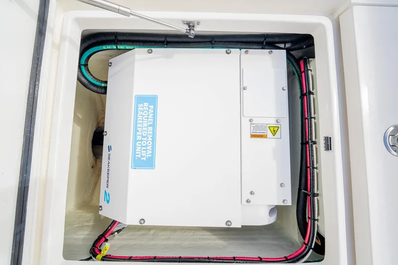 Slide: The Image of Seakeeper unit in SeeVee 32 boat, 2099 model, with wiring and panel removal instructions. - 48