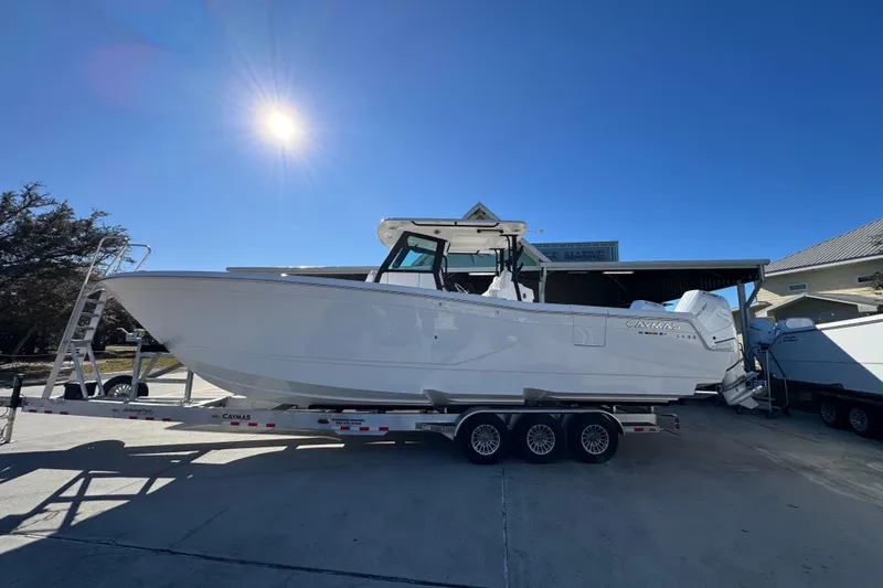 The Image of 2026 Caymas 34 CT boat on trailer under bright sun. - 1