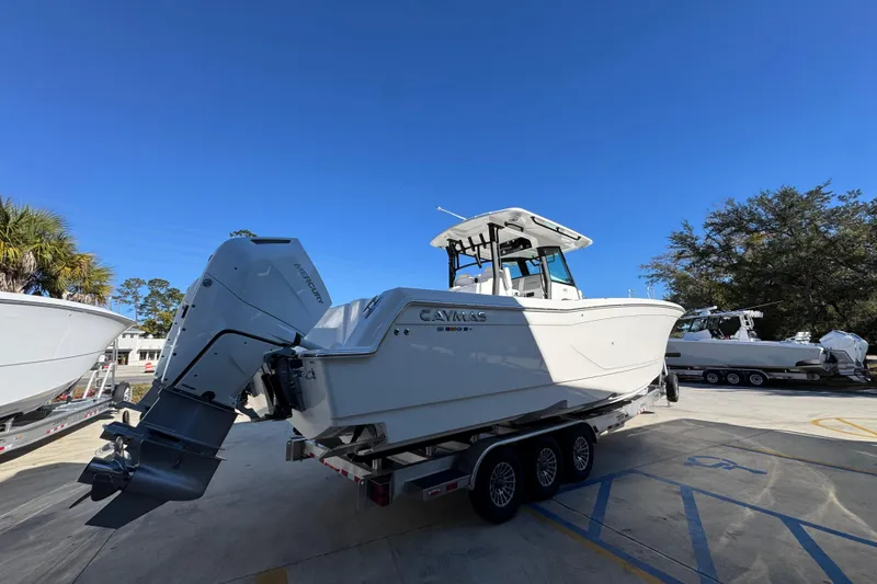 Slide: The Image of 2026 Caymas 34 CT boat on trailer under clear blue sky. - 10