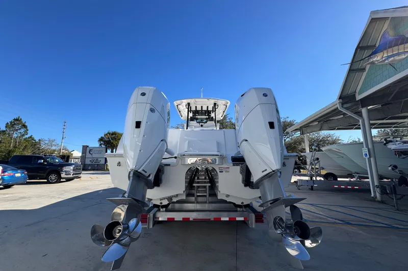 Slide: The Image of 2026 Caymas 34 CT boat with dual outboard motors in a marina setting. - 11