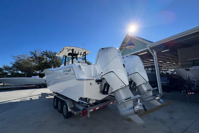 Slide: The Image of 2026 Caymas 34 CT boat with dual outboard engines in a sunny marina setting. - 12
