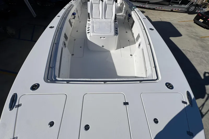 Slide: The Image of 2026 Caymas 34 CT boat deck with seating and storage compartments. - 14