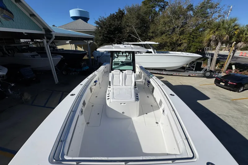 Slide: The Image of 2026 Caymas 34 CT boat in a marina, showcasing sleek design and spacious deck. - 15