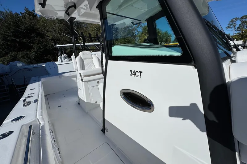 Slide: The Image of 2026 Caymas 34 CT boat, white exterior, spacious deck, modern design, outdoor setting. - 22