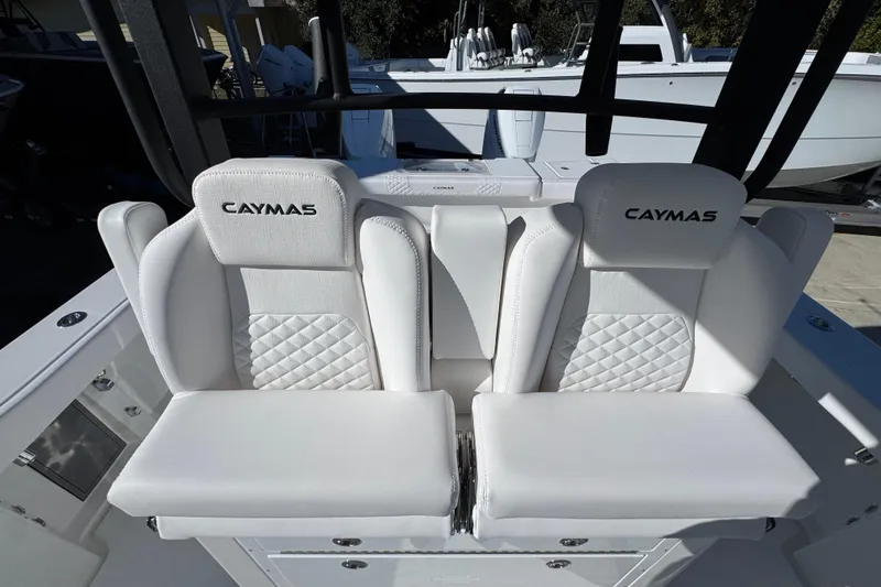 Slide: The Image of 2026 Caymas 34 CT boat seats with white quilted upholstery and branding. - 25