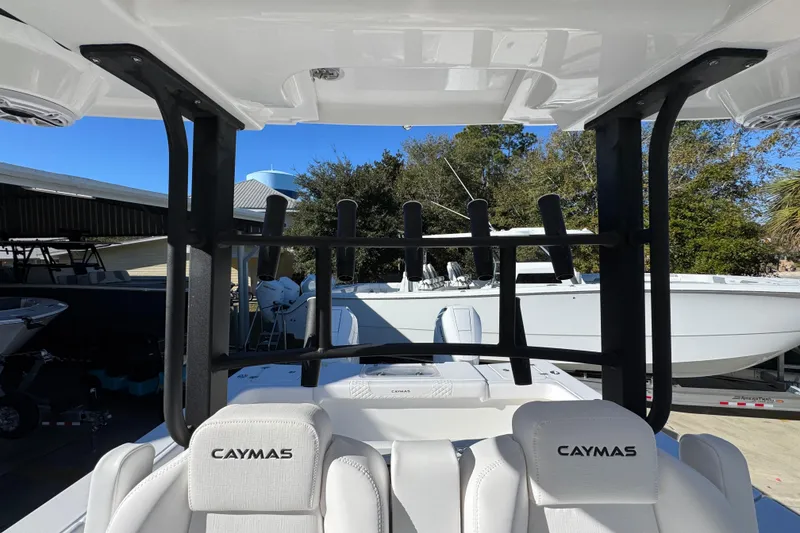 Slide: The Image of 2026 Caymas 34 CT boat interior with rod holders and branded seating. - 26