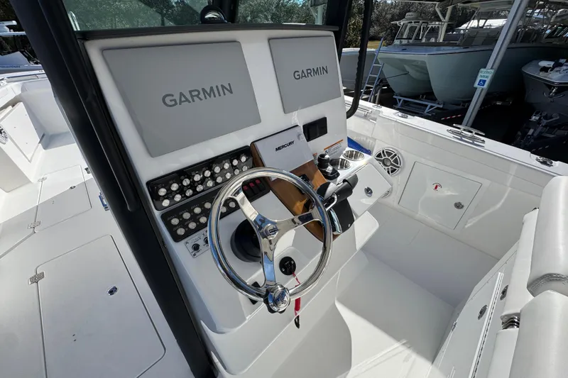 Slide: The Image of 2026 Caymas 34 CT boat cockpit with Garmin navigation system and modern controls. - 27