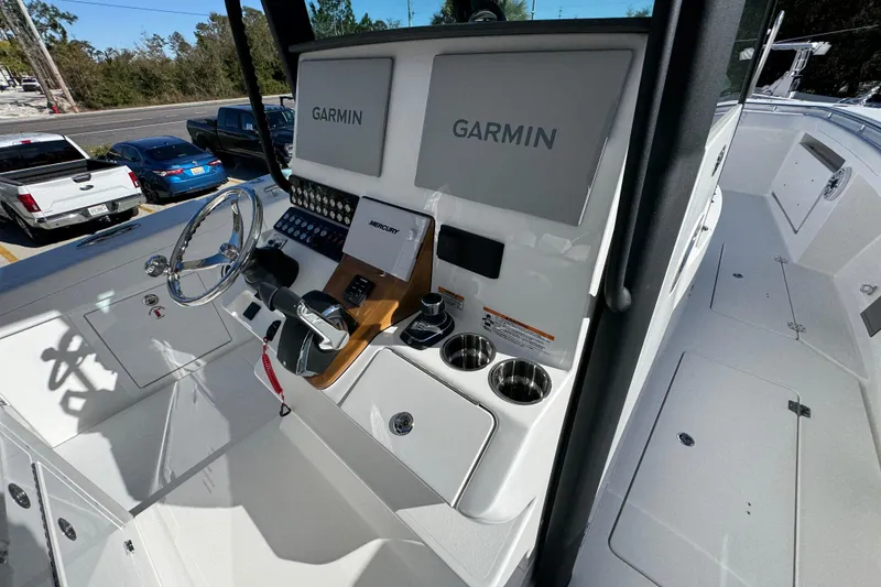 Slide: The Image of 2026 Caymas 34 CT boat cockpit with Garmin navigation and Mercury controls. - 29