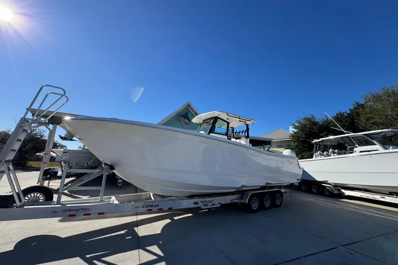 Slide: The Image of 2026 Caymas 34 CT boat on trailer under clear blue sky. - 3