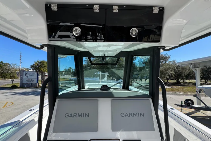 Slide: The Image of 2026 Caymas 34 CT boat interior with Garmin navigation system, docked outdoors. - 30