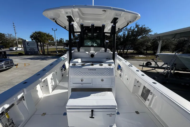 Slide: The Image of 2026 Caymas 34 CT boat with sleek design and modern features, docked outdoors. - 34
