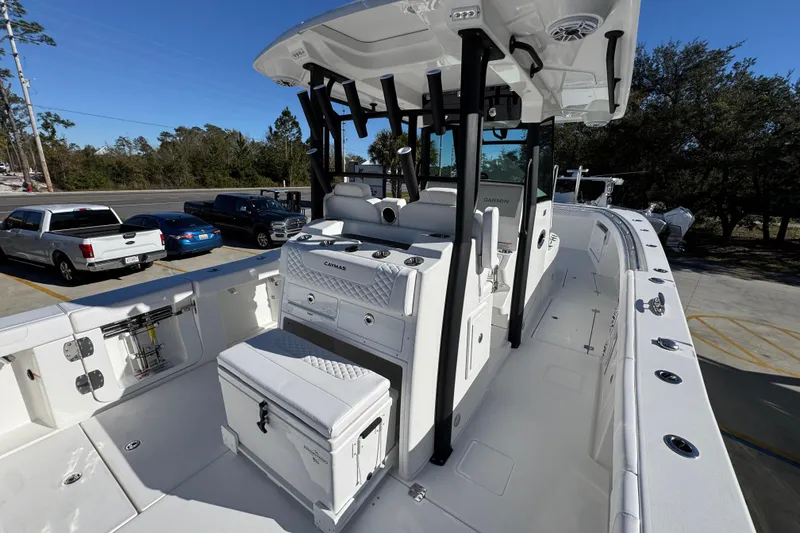 Slide: The Image of 2026 Caymas 34 CT boat with sleek design and modern features, parked outdoors. - 35