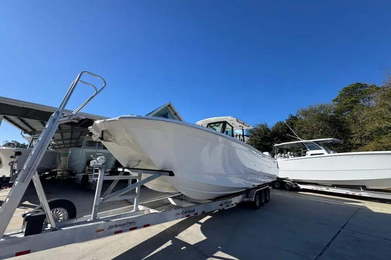Slide: The Image of 2026 Caymas 34 CT boat on trailer under clear blue sky. - 4